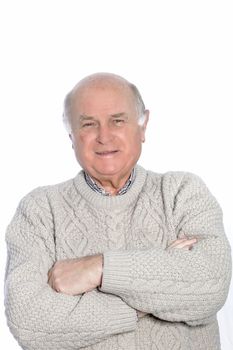 Portrait of a mature balding man, dressed in a knit sweater with arms crossed.