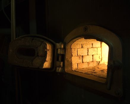 Burning Brick Wall stove in dark environment