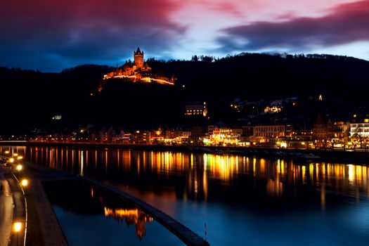 illuminated city and castle close to river in Cochem (Mosel) with long exposure