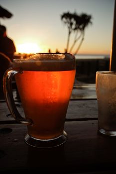 Close up shot of a glass of tea against the sunset background