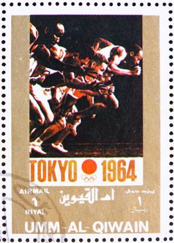 UMM AL-QUWAIN - CIRCA 1972: a stamp printed in the Umm al-Quwain shows Tokyo 1964, Japan, Olympic Games of the past, circa 1972
