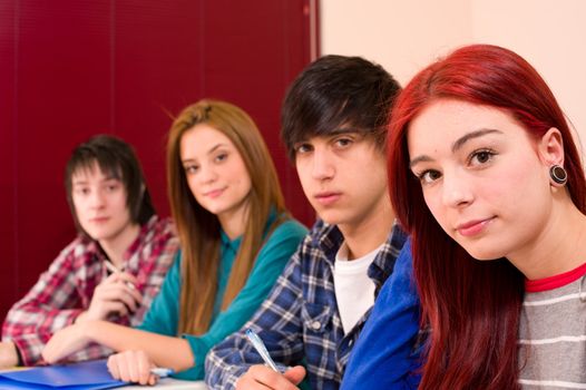 Teenage students in classroom looking at camera