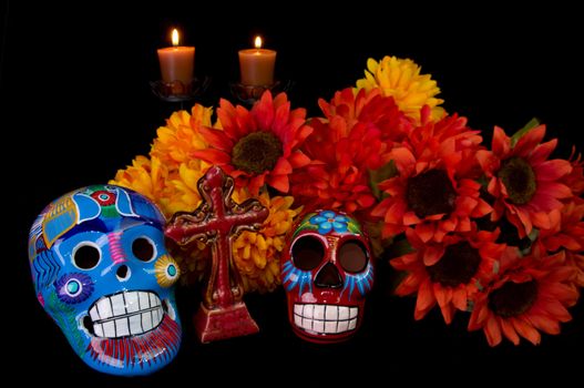 Dia De Los Muertos (Day of the Dead) Alter with decorated sugar skulls, marigold flowers, candles, and cross. Traditional Mexican offering to loved ones