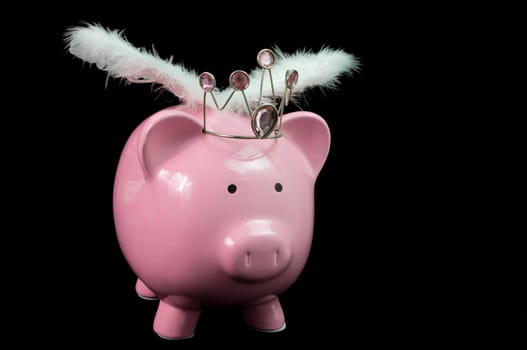pInk piggy bank with wings on black background