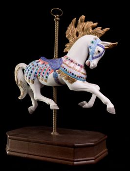 Colorful carousel horse isolated on black background