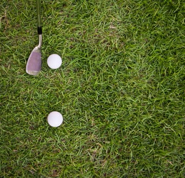 golf ball and iron on  grass