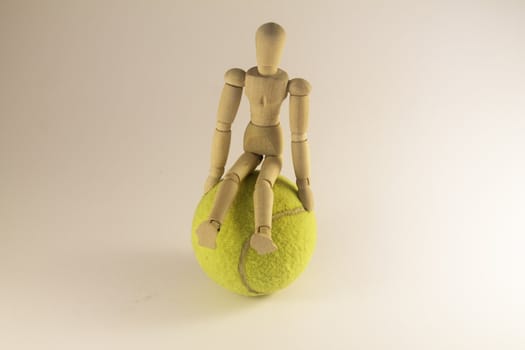 Dummy seated on a tennis ball