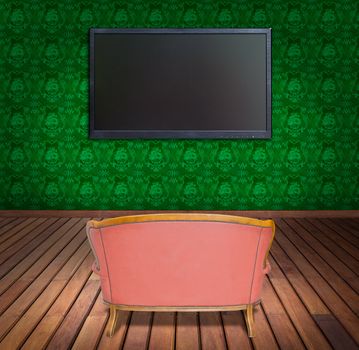television and sofa in green wallpaper room