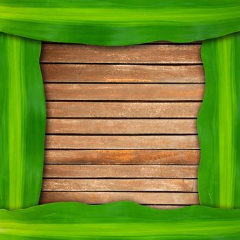 green leaves frame on wood background