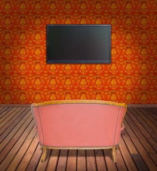 television and sofa in orange wallpaper room