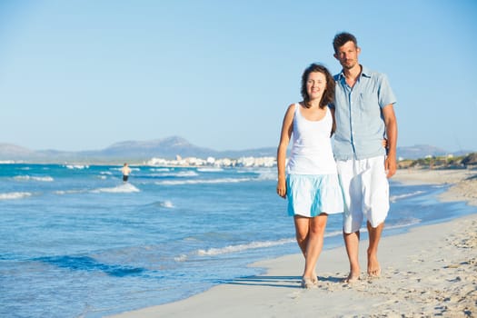 Portrait of a romantic happy young couple together on the beach