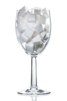 Wine glass filled with white sugar cubes. Isolated.