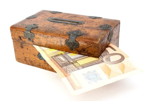 money partly in wooden box over white background