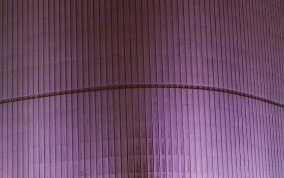 Purple building background with vertical lines pattern.