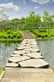 stone walkway on water in the park