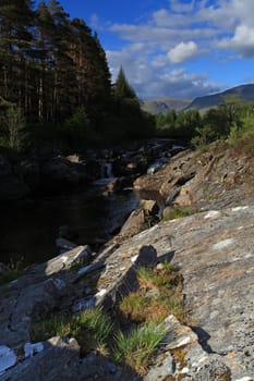 Rural countryside waterfall taken with slow shutter speed in Glencoe Scotland