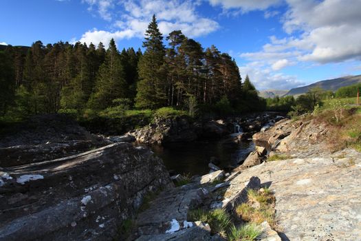 Rural countryside waterfall taken with slow shutter speed in Glencoe Scotland