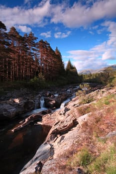 Rural countryside waterfall taken with slow shutter speed in Glencoe Scotland