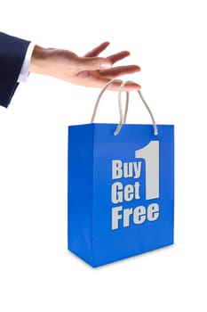 sale label on blue shopping  paper bag in hand