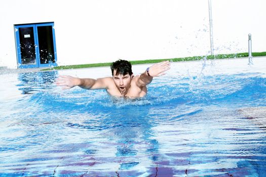 man swims in swimming pool