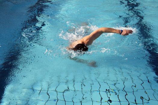 man swims in swimming pool