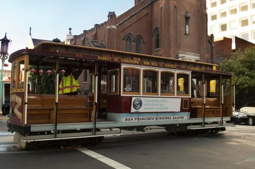 SAN FRANCISCO - MAY 25: Passengers enjoy a ride in a cable car on MAY 25, 2012 in San Francisco. It is the oldest mechanical public transport in San Francisco which is in service since 1873.