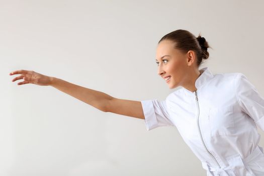 Young female doctor in white uniform at workplace