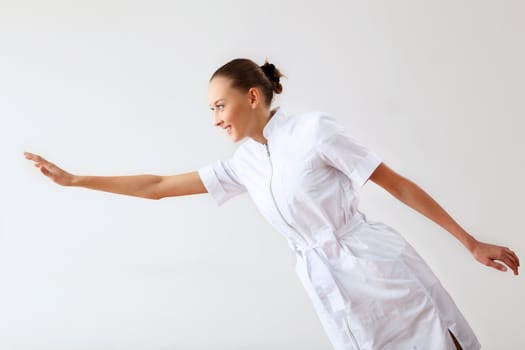 Young female doctor in white uniform at workplace