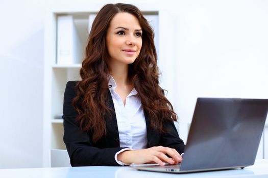 Young pretty business woman with notebook in the office