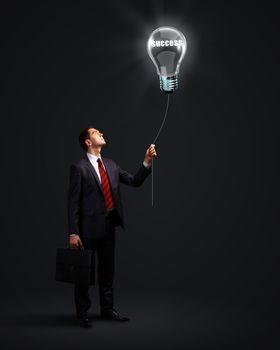 Light bulb and a business person as symbols of creativity in business