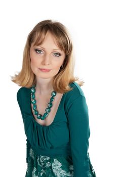 beauty portrait of a blonde in a green dress isolated on white background