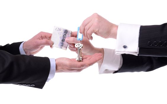 two men exchanging keys for money isolated on white background