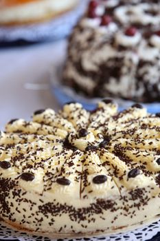 Selection of gourmet freshly baked creamy cakes on a buffet table at a catered event or wedding reception