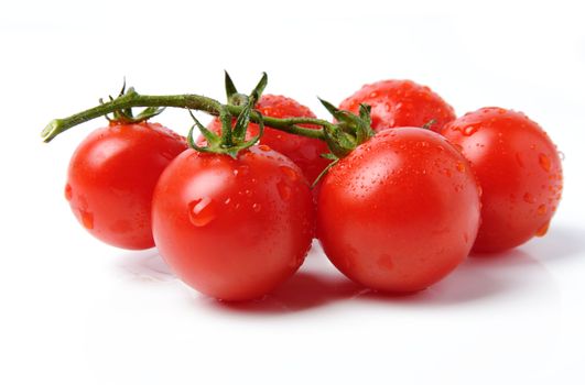 An image of red tomatoes with drops of water on them