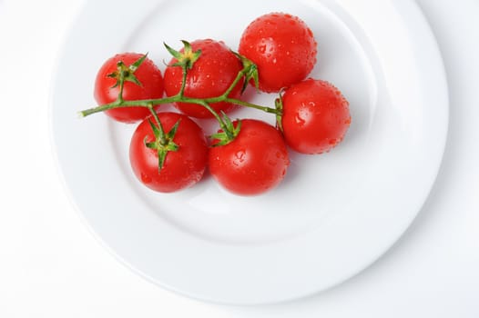 An image of fresh red tomatoes on a plate