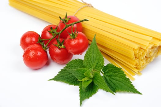 An image of pasta and fresh red tomatos on white background