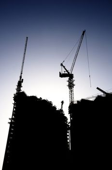 construction site silhouette against blue sky