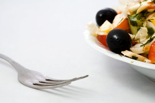 Stock photo: an image of fork and a plate of tasty salad