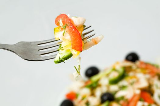 Stock photo: an image of a fork with some fresh salad on it