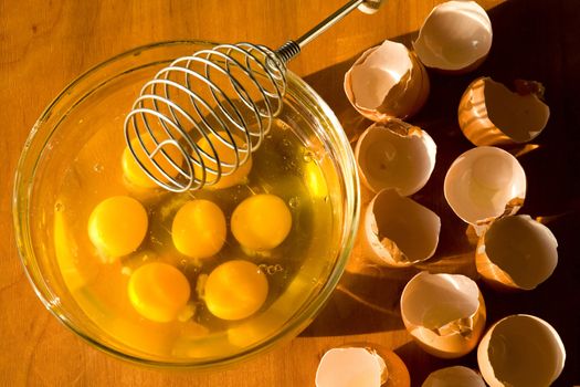 A glass plateful of eggs while an omelette preparing

