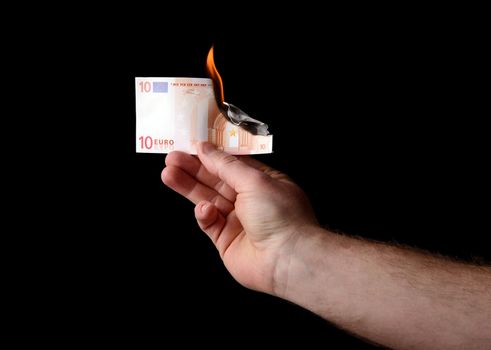euro note burning on a isolated black background