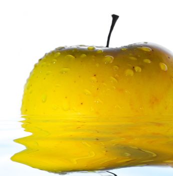 Stock photo: nature theme: an image of water drops on a yellow apple