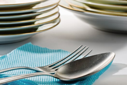 Stock photo: an image of silver spoon and fork on blue napkin