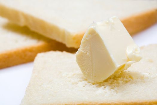 Stock photo: an image of fresh butter on a slice of bread
