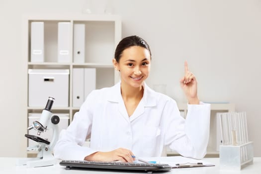 Young female doctor in white uniform at workplace