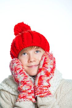 Portrait of young smiling cute teenager in a red hat and mittens, isolated on white