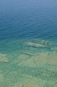 Rippled pattern background of clean and transparent water in Garda Lake, Northern Italy