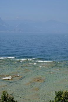 Rippled pattern background of clean and transparent water in Garda Lake, Northern Italy