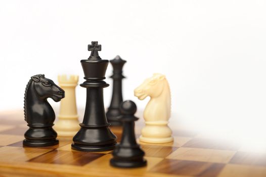 chess pieces on a white background advising to strategic behavior