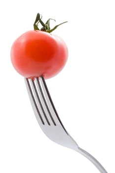 ripe tomato on fork isolated